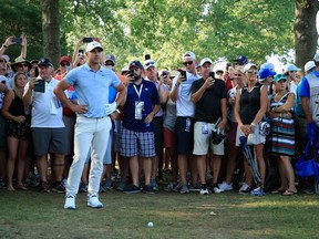 Brooks Koepka inspects his situation off the 15th fairway during the third round of the PGA Championship on Saturday.