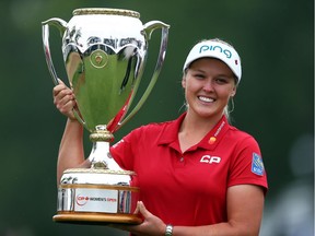 Brooke Henderson of Smith Falls hoists the champion's trophy following the final round of the CP Women's Open at Regina on Sunday.