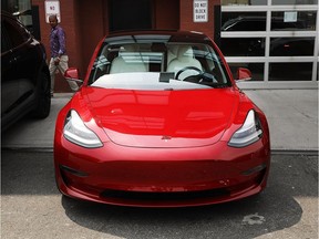Tesla vehicles stand outside of a Brooklyn showroom and service centre in New York on Monday.