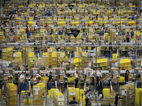 Parcels are prepared for dispatch at Amazon's warehouse on December 5, 2014 in Hemel Hempstead, England.