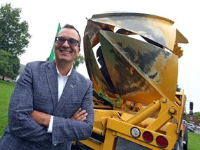 Louis-Alexandre Lanthier, senior manager for Government Affairs, stands in front of a tree mover.