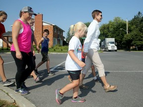 Francine Beaupre, right, leads kids across Pleasant Park Road at Delmar Drive where neighbours have been lobbying to have an adult crossing guard for the school year.
