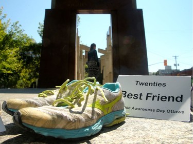 About a 100 people gathered in front of the Human Rights Monument at Ottawa City Hall Friday (August 31, 2018) for International Overdose Awareness Day. Just over sixty pairs of shoes were laid out at the foot of the monument to symbolize the amount of overdose deaths in Ottawa last year.  Speakers aimed to raise awareness of overdose hazards and reduce the stigma of drug use.