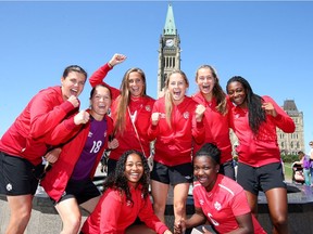 Canadian team captain Christine Sinclair, far left, and a handful of teammates pose for a photo in front of the Peace Tower on Parliament Hill on Thursday. Joining Sinclair for the event were, top row left to right, Erin McLeod, Shelina Zadorsky, Janine Beckie, Jordyn Huitema, Maya Antoine and, bottom row left to right, Jayde Riviera and Deanne Rose.