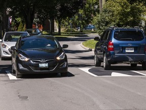 Vehicles cross the "3D" traffic calming measure that the City of Ottawa has installed on Othello Avenue. The vehicle on the right braked as it approached the markings. August 10, 2018.