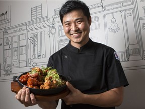 Table Sodam chef/owner Sean Nam with Yang Nyum Chicken/Ganjang Chicken, a whole chicken with signature sweet and spicy or sweet soy sauce. August 14, 2018. Errol McGihon/Postmedia