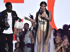 Nicki Minaj accepts the award for best hip-hop video for "Chun-Li" as presenter Kevin Hart looks on at the MTV Video Music Awards at Radio City Music Hall on Monday, Aug. 20, 2018, in New York.