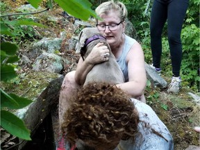 Owner 'Hayley' hus her dog Dobbie, rescued from a narrow rock crevice.