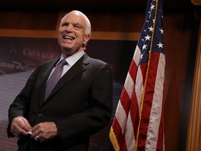 Sen. John McCain laughs during a news conference to announce opposition to the so-called skinny repeal of Obamacare at the U.S. Capitol July 27, 2017 in Washington, DC.