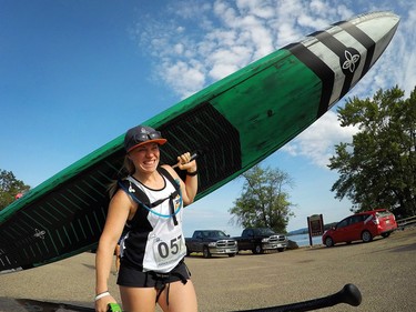 Jamie Lee Moir walks her SUP board over to Petawawa Point Beach before the 13km race kicked off.