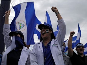 University students and medical doctors, dismissed from public hospitals for treating wounded anti-government protesters, march against Nicaraguan President Daniel Ortega in Managua, Nicaragua, on July 3.