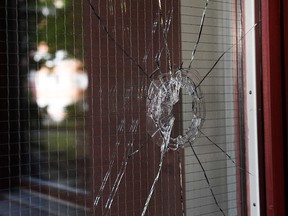 A hole in a glass door is seen at the site where 20-year-old autistic man with Down Syndrome holding a toy gun was shot by police in Stockholm, on August 3, 2018.