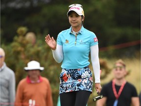 Thailand's Pornanong Phatlum acknowledges the applause from spectators after she putts in the third round of the Women's British Open Golf Championships at Royal Lytham & St. Annes Golf Club on Saturday.