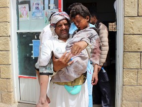 EDITORS NOTE: Graphic content / A man transports a child to a hospital after he was wounded in a reported air strike on the Iran-backed Huthi rebels' stronghold province of Saada August 9, 2018. - A Saudi-led coalition battling in Yemen said it carried out an attack in the rebel-held north today that the Red Cross said hit a bus carrying children, leaving dozens of people dead or wounded.