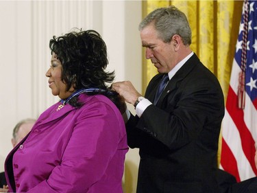 In this file photo taken on November 9, 2005 US President George W. Bush presents the Presidential Medal of Freedom, the nation's highest civil award, to singer Aretha Franklin (L) as actor Andy Griffith (R) watches in the East Room of the White House in Washington, DC.