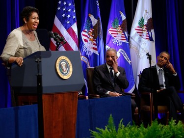 In this file photo taken on February 27, 2015 Outgoing Attorney General Eric Holder (C) wipes his eye next to US President Barack Obama as they listen to singer Aretha Franklin at the Justice Department in Washington, DC. - Aretha Franklin died at the age of 76 on August 8, 2018 at her home in Detroit according to her publicist.