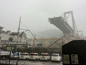 This handout picture provided by the Italian police (Polizia di Stato) on August 14, 2018 shows a collapsed section of a viaduct on the A10 motorway in Genoa. - A section of a viaduct on the A10 motorway collapsed on August 14, 2018 in Genoa, Italian firefighters said, with cars and trucks trapped among the rubble. Television images showed the viaduct in the mist with a huge chunk missing, with Italian media reporting that 200 metres of the "Morandi" bridge had fallen away.