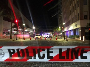 This photo shows a police car behind police tape blocking a street leading to the Jacksonville Landing area in downtown Jacksonville, Florida, August 26, 2018, where three people were killed, including the gunman, and 11 others wounded. - Two people were killed and 11 others wounded on August 26 when a video game tournament competitor went on a shooting rampage before turning the gun on himself in the northern Florida city of Jacksonville, local police said. Sheriff Mike Williams named the suspect of the shooting at a Madden 19 American football eSports tournament as 24-year-old David Katz from Baltimore, Maryland.