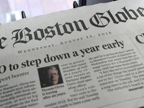 (FILES) In this file photo taken on August 15, 2018 copies of the Boston Globe. The newspaper recently organized a newspaper editorial response to attacks on the media by US President Donald Trump.