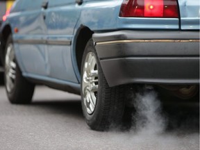 (FILES) This file photo taken on October 23, 2017 shows a car emits fumes from its exhaust.