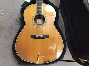 A 1978 Larrivee guitar owned by Remi Claude Arsenault is shown following being damaged by an Air Canada fork lift in this recent handout photo. It's a one-of-a-kind guitar, an instrument so beloved musician Remi Claude Arsenault calls it his "best friend." But the handmade Larrivee met its match with an airport forklift that left gaping stab wounds in the body of the vintage 1978 guitar. Arsenault said Friday he was on his way home from the Milwaukee Irish Fest, where he was performing with Natalie MacMaster, Donnell Leahy and family, when the irreparable damage occurred.