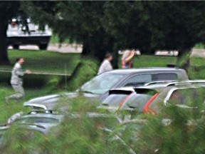 People with their hands up come out amid reports of an active shooter at Wright-Patterson Air Force base in Ohio on Thursday, Aug. 2, 2018.