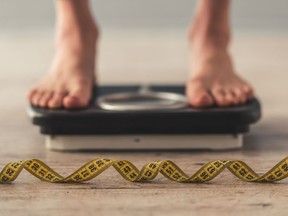 Cropped image of woman feet standing on weigh scales, on gray background.Her weight kept decreasing and at one point reached 32 kilograms, health-care workers providing her treatment have said.