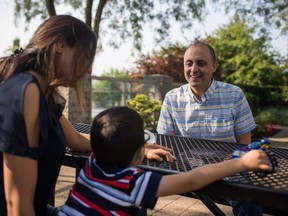 Ali Manavi is pictured near his wife Naghmeh and their son Arteen at their home in Vancouver, British Columbia on August 16, 2018. (