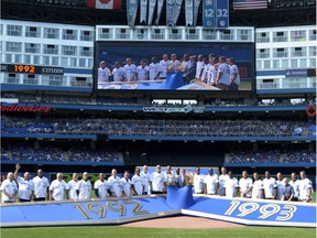 Members of the 1992 and 1993 World Series-winning Toronto Blue Jays teams are recognized before Saturday's game against the Tampa Bay Rays in Toronto.
