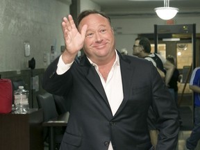 FILE - In this Wednesday, April 19, 2017, file photo, Alex Jones, a right-wing radio host and conspiracy theorist, arrives for a child custody trial at the Heman Marion Sweatt Travis County Courthouse in Austin, Texas. The music streaming service Spotify says it has removed some episodes of "The Alex Jones Show" podcast for violating its hate content policy. The company said late Wednesday that it takes reports of hate content seriously and reviews any podcast or song reported by customers.