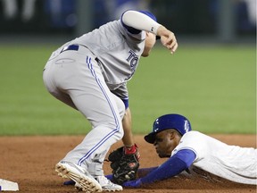 Toronto Blue Jays shortstop Aledmys Diaz, left, tags out Kansas City Royals' Rosell Herrera, right, as he attempts to steal second base in the sixth inning of a baseball game at Kauffman Stadium in Kansas City, Mo., Monday, Aug. 13, 2018.