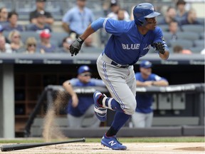 Toronto Blue Jays left fielder Curtis Granderson hits a single off New York Yankees starting pitcher Luis Severino during the first inning of a baseball game, Saturday, Aug. 18, 2018, in New York.