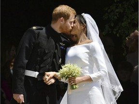 Prince Harry and Meghan Markle kiss for photographers after their wedding ceremony at St. George's Chapel in Windsor Castle on May 19. Ben Birchhall/pool photo via AP, File