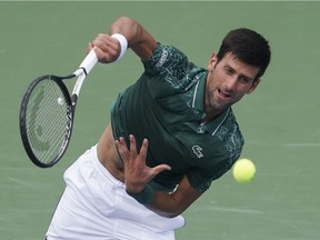 Novak Djokovic serves to Milos Raonic during their quarterfinal match on Friday at Cincinnati.