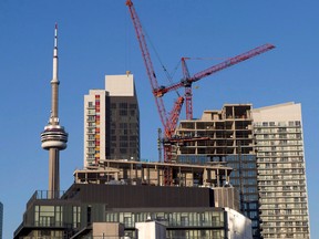 A file photo of construction cranes and the Toronto skyline.