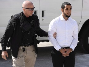 A lawyer for accused extremist recruiter Awso Peshdary says Canada's spy agency obtained a warrant to monitor the Ottawa man based on misleading information. Peshdary, who is accused of recruiting for ISIL, is escorted by police as he arrives for a hearing at the Supreme Court of Canada in Ottawa on Monday, Aug. 13, 2018.