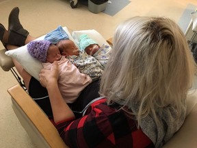 A Saskatchewan woman who had to perform CPR on one of her newborn triplets says all three babies are currently doing awesome. Danielle Johnston holds her new triplets Karlee, Liam and Jack in an undated handout photo.