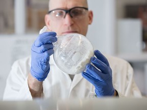 Frank St. Michael, a technical officer with the Human Health Therapeutics group at the NRC who on the Hia vaccine holds a sample of an isolated polysaccharide, which is the basis of a vaccine.  NRC photo