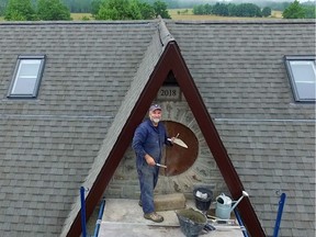 Steve Maxwell setting the last few stones in the last peak on the home he built on Manitoulin Island, Ontario.