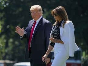 President Donald Trump and first lady Melania Trump walk across the South Lawn of the White House in Washington, Friday, Aug. 24, 2018, to board Marine One helicopter for a short trip to Andrews Air Force Base, Md., en route to Columbus, Ohio.