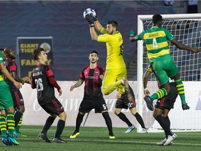Fury FC goalkeeper Maxime Crépeau (in yellow) pulls in a high ball lofted in front of the net by the Rowdies during Friday's game.  Steve Kingsman/Freestyle Photography for Ottawa Fury FC