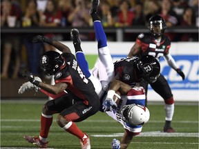 Montreal Alouettes' Ernest Jackson (9) gets upended after being tackled by Ottawa Redblacks' Jonathan Rose (9) and Quentin Gause (32) during second half CFL action in Ottawa on Saturday, Aug. 11, 2018.