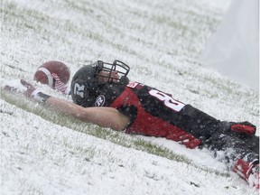 The Redblacks' Greg Ellingson makes a snow angel after scoring a touchdown against the Eskimos in the 2016 East Division final.