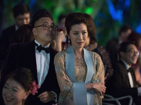 This image released by Warner Bros. Entertainment shows Nico Santos, left, and Michelle Yeoh in a scene from the film "Crazy Rich Asians."