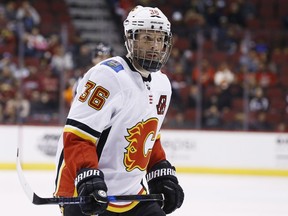 FILE - In this Feb. 22, 2018, file photo, Calgary Flames right wing Troy Brouwer (36) pauses on the ice during the first period of an NHL hockey game against the Arizona Coyotes, in Glendale, Ariz. The Calgary Flames have placed assistant captain Troy Brouwer on unconditional waivers with the intention of buying out the remaining two years of his contract. The move was announced by the team Thursday, Aug. 2, 2018, and will save the Flames $3 million in space under the salary cap in each of the next two seasons.