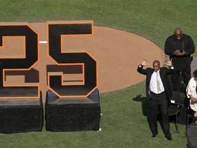 Former San Francisco Giants player Barry Bonds waves to fans next to his mother, Pat, as he is honored during a ceremony to retire his jersey number before a baseball game between the Giants and the Pittsburgh Pirates in San Francisco, Saturday, Aug. 11, 2018.