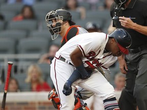 Atlanta Braves' Ronald Acuna Jr. (13) reacts after being hit by a pitch from Miami Marlins' Jose Urena during the first inning of a baseball game Wednesday, Aug. 15, 2018, in Atlanta. Both dugouts emptied and Urena was ejected.