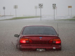 A car is stuck partially submerged in floodwaters from Hurricane Lane rainfall on the Big Island on August 23, 2018 in Hilo, Hawaii. (Mario Tama/Getty Images)