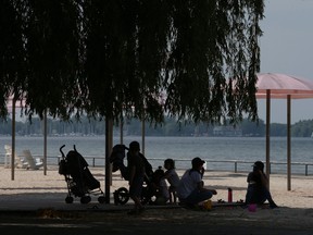 People cool down at Toronto's Sugar Beach during a heat warning.