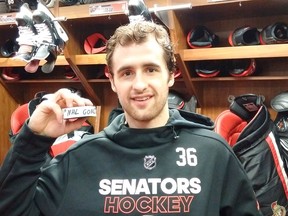 Colin White shows off the puck with which he scored his first NHL goal with the Senators in February. He's one of the young prospects that fans hope will revive the team's fortunes. Bruce Garrioch/Postmedia